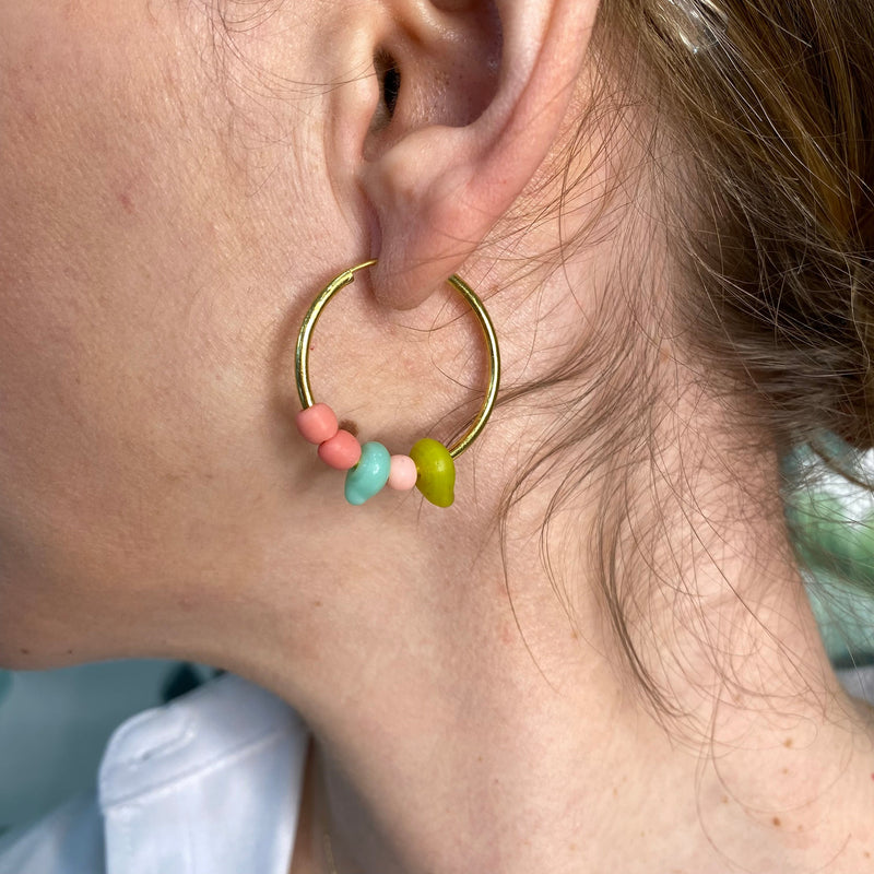 This colorful hoop earrings are effortlessly chic. Handmade by our team of master artisans using a vermeil hoop accented with african beads, pink opal and a pink tourmaline semi-precious stones     Details:  - Handmade earrings  - 24k Gold vermeil Hoop on 925 sterling silver   -Hoop diameter: 25mm   -African Beads, pink opal and a pink tourmaline