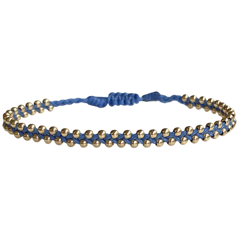 This delicate and beautiful bracelet is handwoven by our team of artisans using 14K gold filled beads and black threads.   You can wear it with your favourite bracelets all season long.   Details:  -14k gold beads details   -Adjustable bracelet  -Width: 3mm  -Can be worn in the water