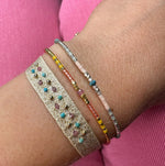 PARIS HANDWOVEN BRACELET FEATURING GEMSTONES AND GOLD DETAILS IN GOLD TONES