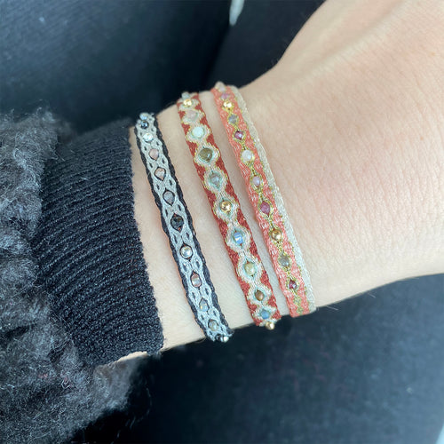 HANDMADE MIX BRACELET IN PINK, GOLD AND NEUTRAL WITH INTERMIXED SEMI PRECIOUS STONES ON MODEL